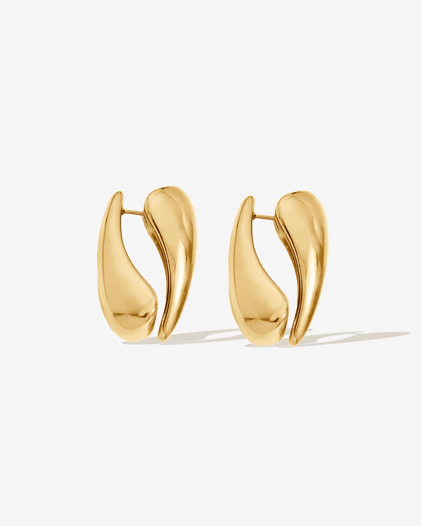 Gold hoop earrings with a modern sculptural shape. Made with two sides for a bold look, or wear as a single-side hoop for a simple style. High-shine finish, lightweight, and easy to wear day or night.