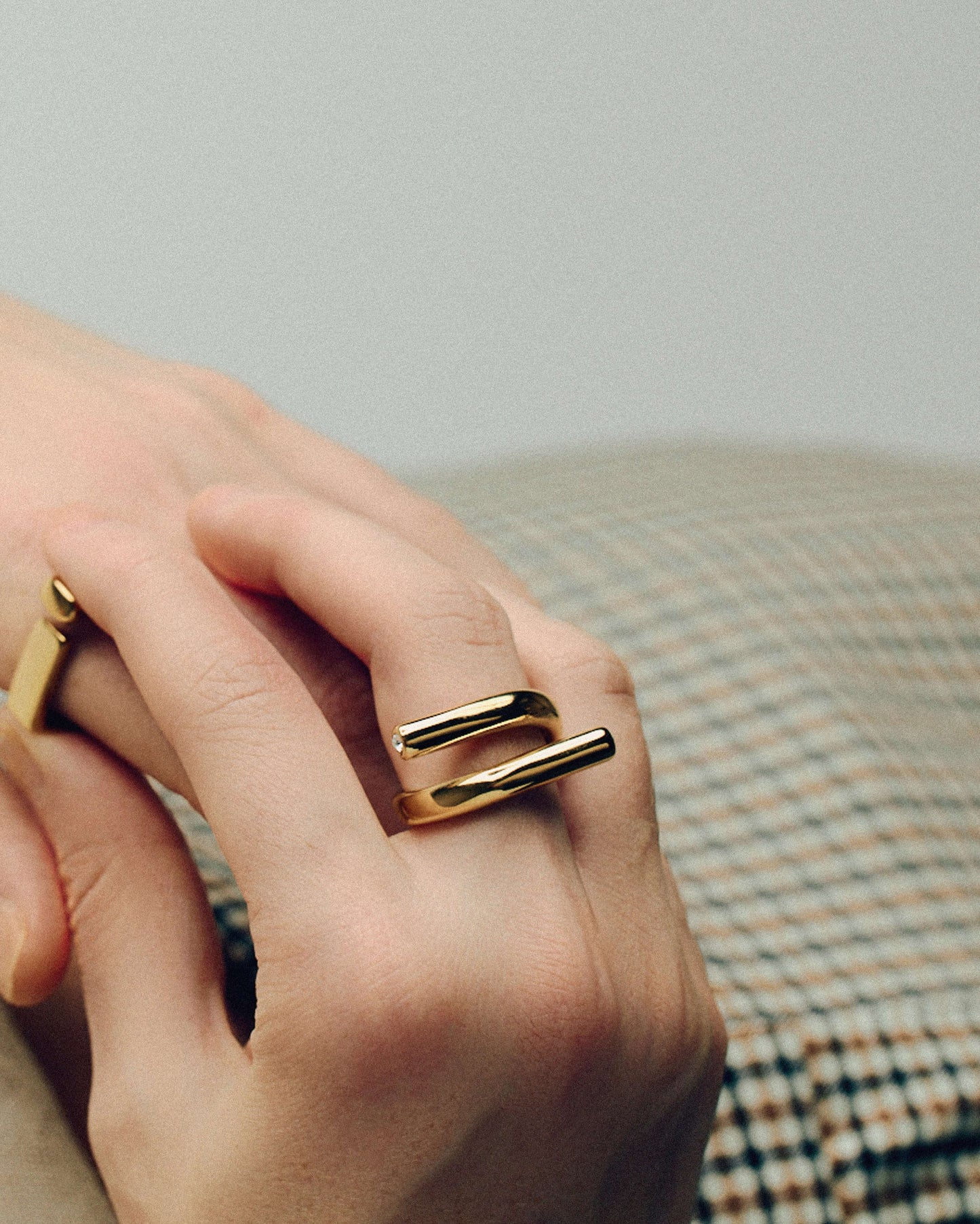 Gold open twist ring with sculptural wrap design, minimal statement band for stacking or solo wear