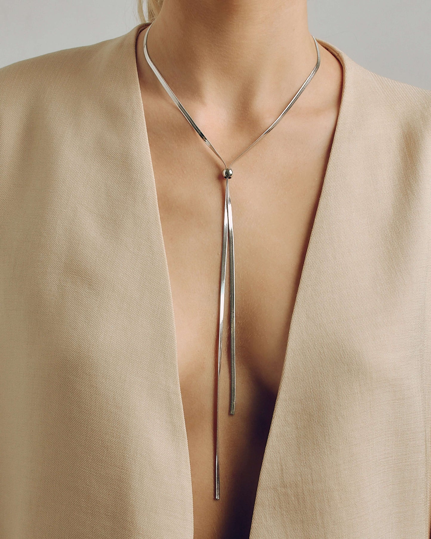 Adjustable gold or silver necklace worn long or as a choker, non-tarnish finish, versatile for layering or statement looks.