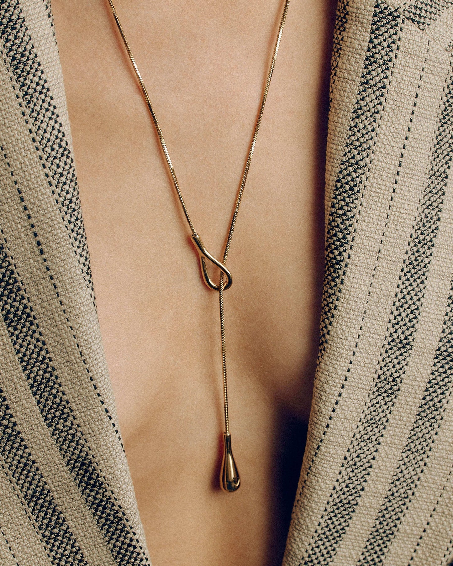 Adjustable gold or silver necklace worn long or as a choker, non-tarnish finish, versatile for layering or statement looks.