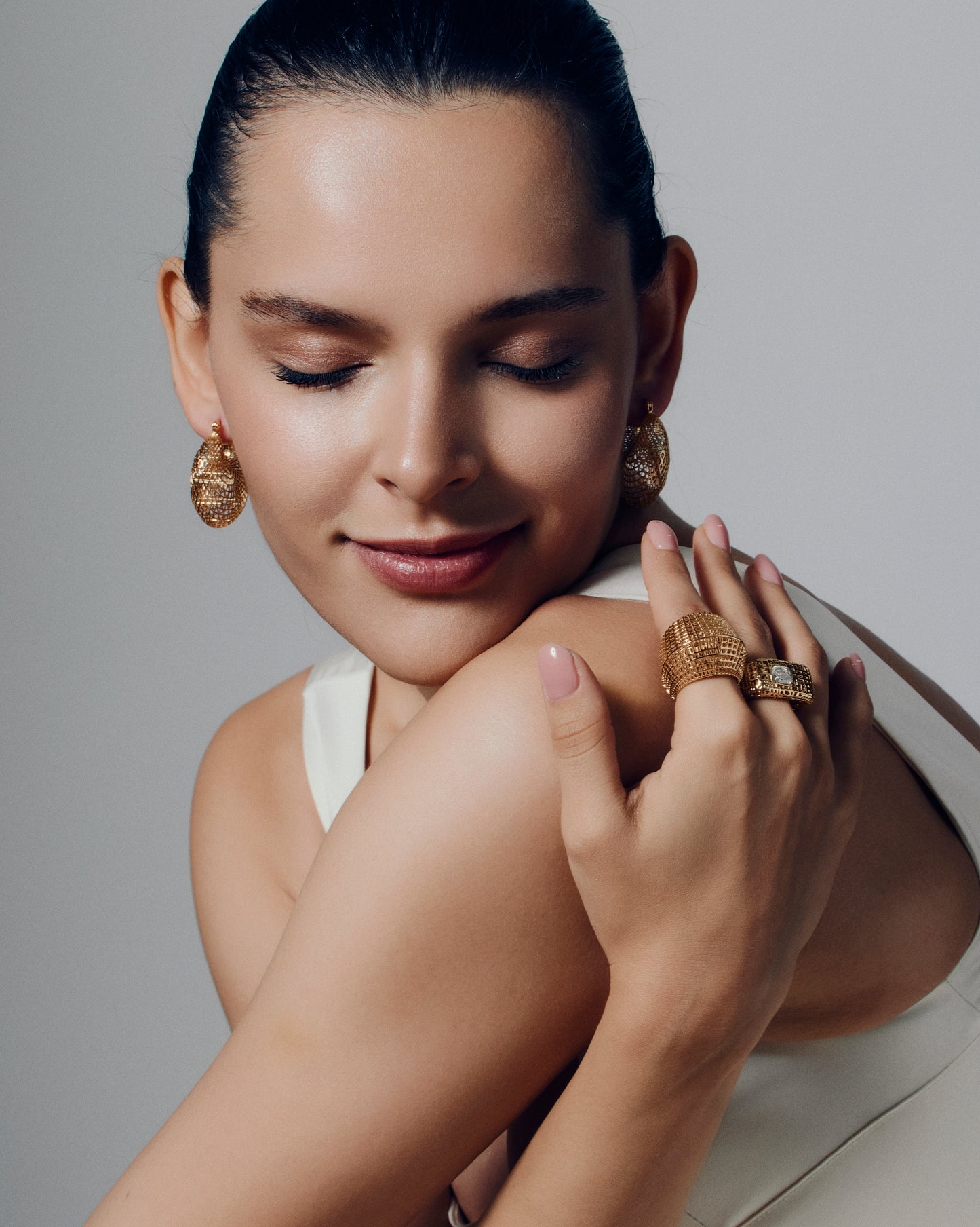 Gold open-work grid ring with a sculptural geometric pattern and bold rounded band. This chunky gold statement ring features a modern lattice texture that gives it depth and dimension while remaining lightweight and comfortable. Crafted in polished gold-tone metal, it adds a refined, architectural edge to everyday or occasion wear.