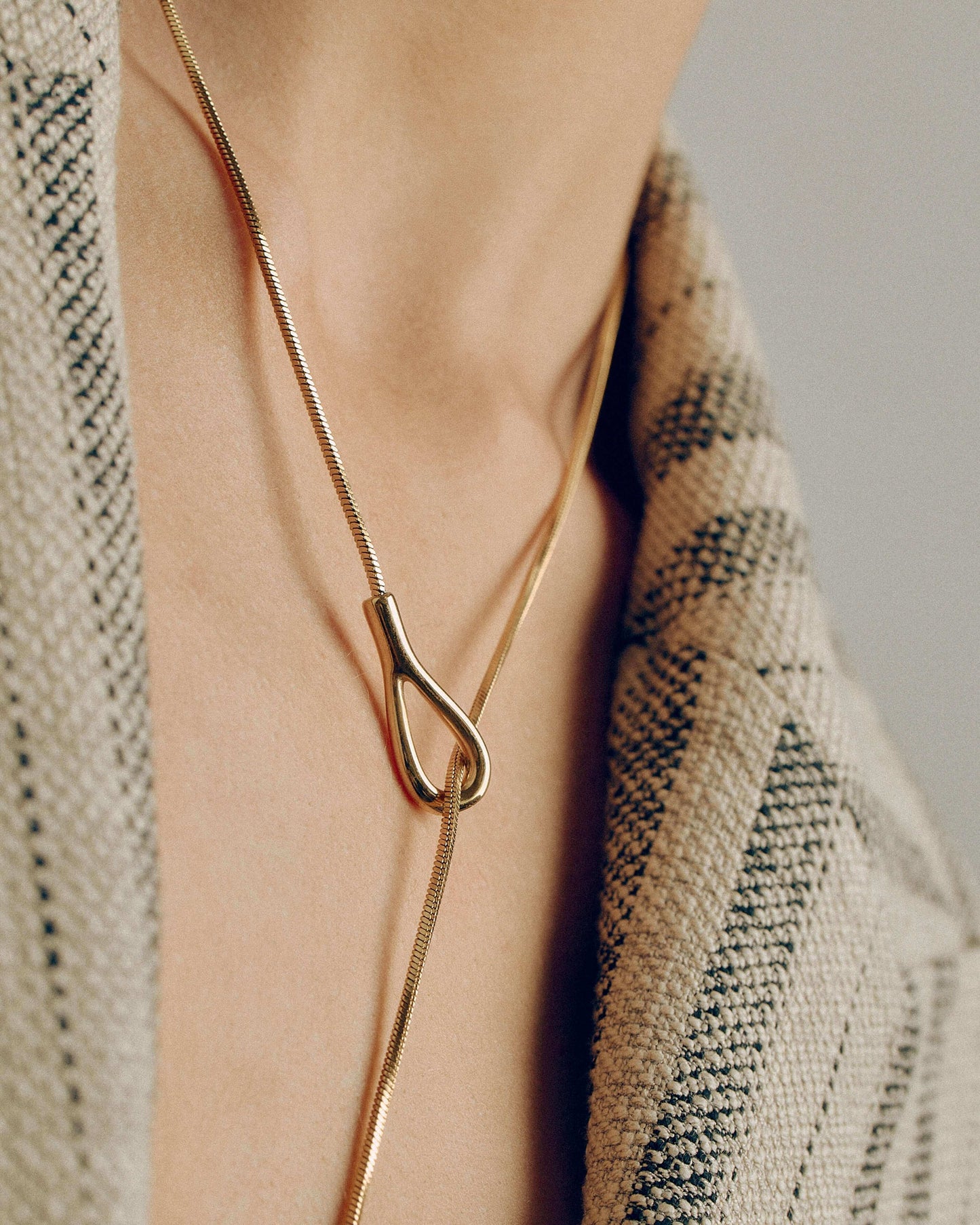 Adjustable gold or silver necklace worn long or as a choker, non-tarnish finish, versatile for layering or statement looks.