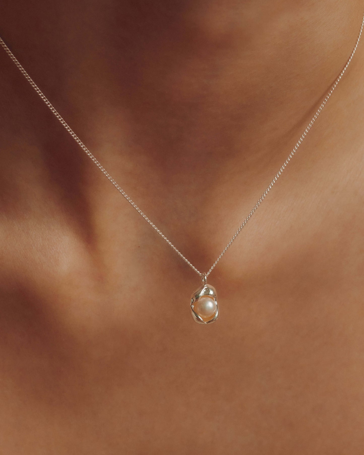 Dainty freshwater pearl pendant necklace on a delicate chain, perfect for everyday wear or adding a soft, elegant statement.