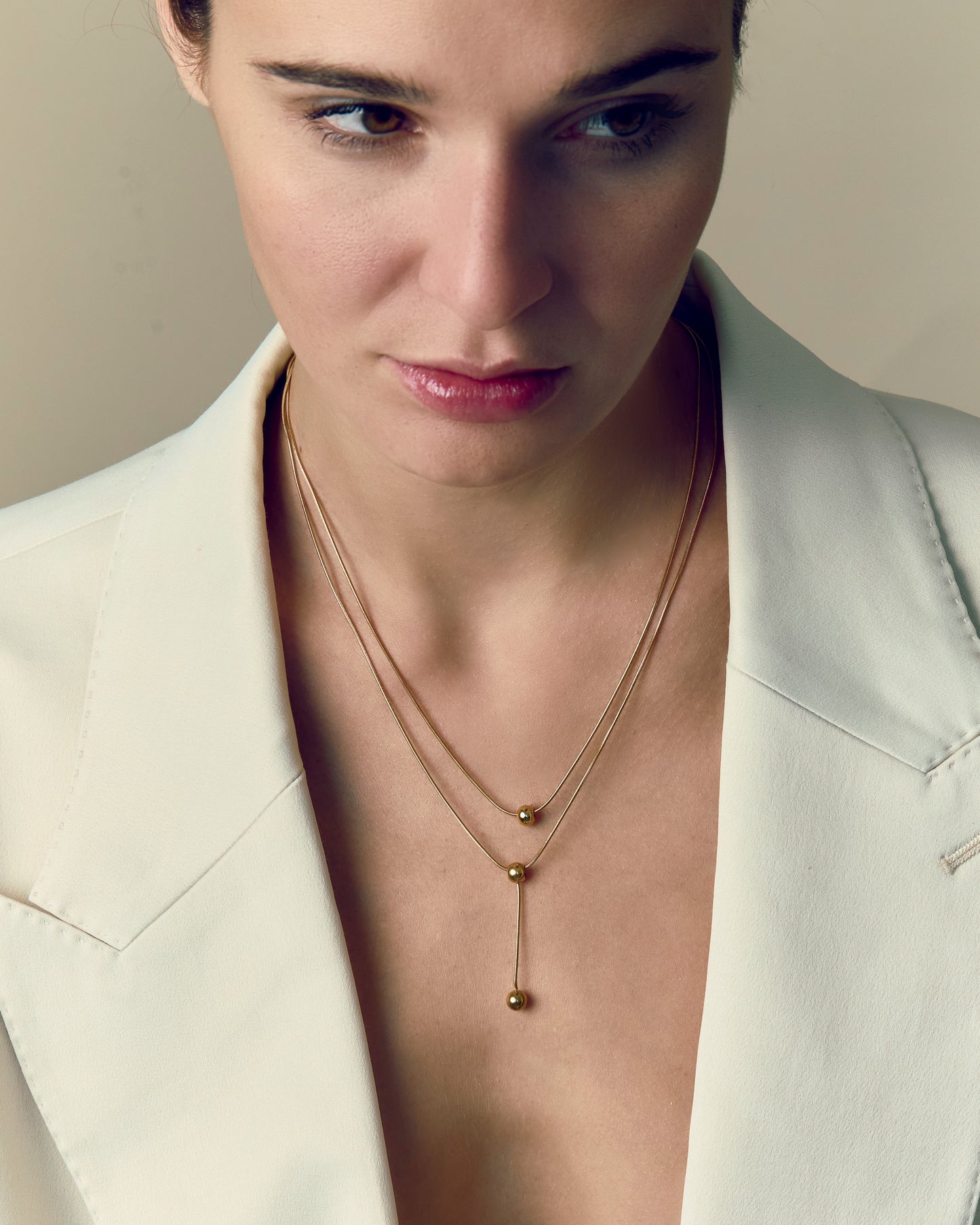 Double-strand 18K gold plated necklace with layered chains and polished ball pendants, delicate and modern for everyday or statement wear.