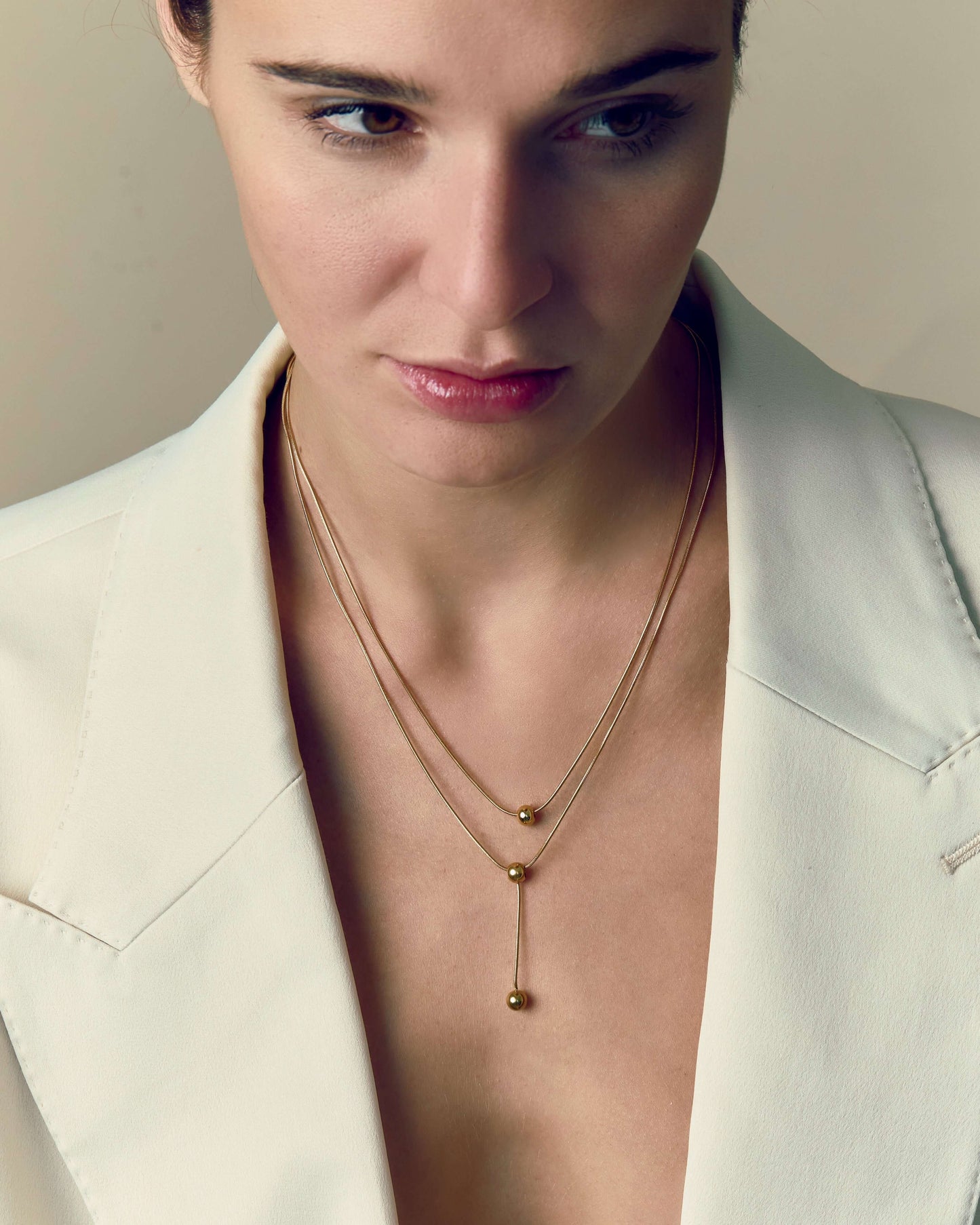 Double-strand 18K gold plated necklace with layered chains and polished ball pendants, delicate and modern for everyday or statement wear.