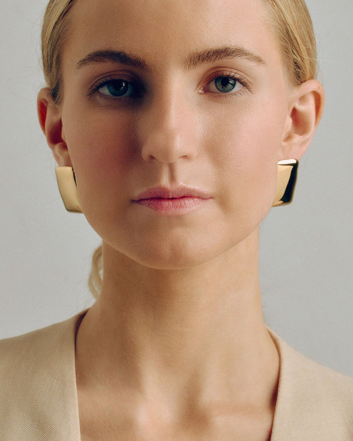 Bold gold rectangle stud earrings with a chunky, sculptural design and high-shine finish. Modern geometric statement studs perfect for everyday or occasion wear.