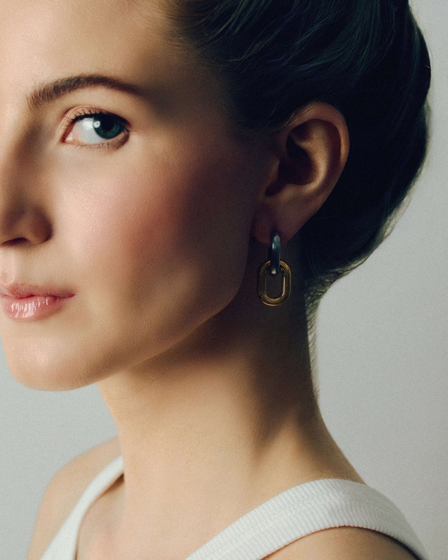 Two-tone link drop earrings with chunky silver and gold oval links stacked together. Modern statement earrings with sleek polished finish, lightweight and easy to wear. Perfect for everyday outfits or adding a chic, bold touch to evening looks. Contemporary geometric design ideal for fashion-forward styling.