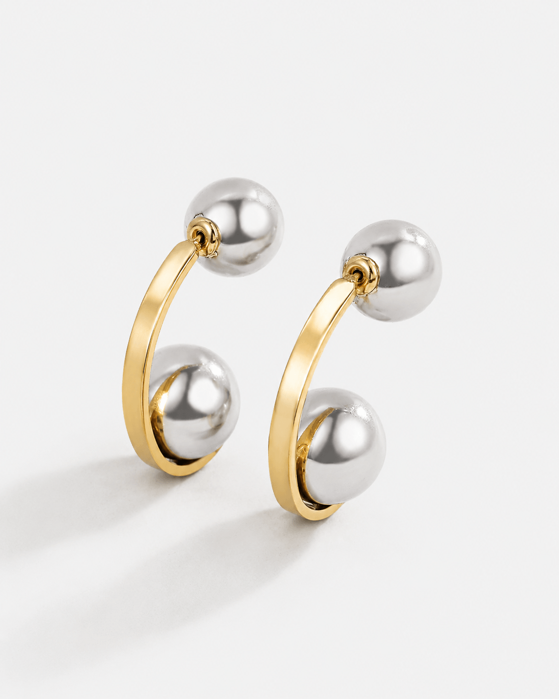 Chunky two tone ear jacket hoop earrings with front and back design in gold and silver, modern statement earrings for women, bold mixed metal hoops, trendy contemporary jewelry for everyday wear or special occasions