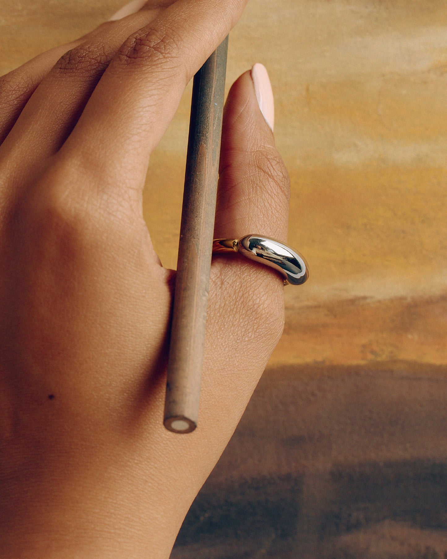 Chunky tubular ring in gold and silver tones – bold two-tone statement piece.