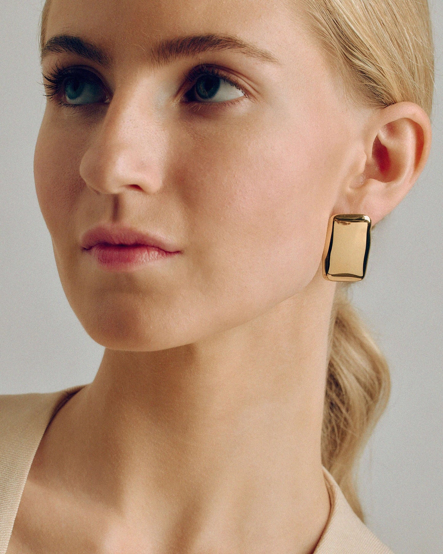 Bold gold rectangle stud earrings with a chunky, sculptural design and high-shine finish. Modern geometric statement studs perfect for everyday or occasion wear.