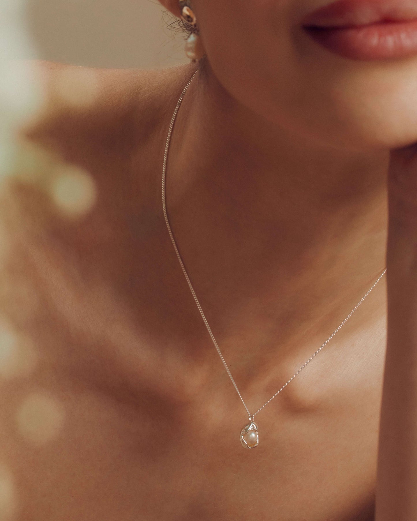 Dainty freshwater pearl pendant necklace on a delicate chain, perfect for everyday wear or adding a soft, elegant statement.
