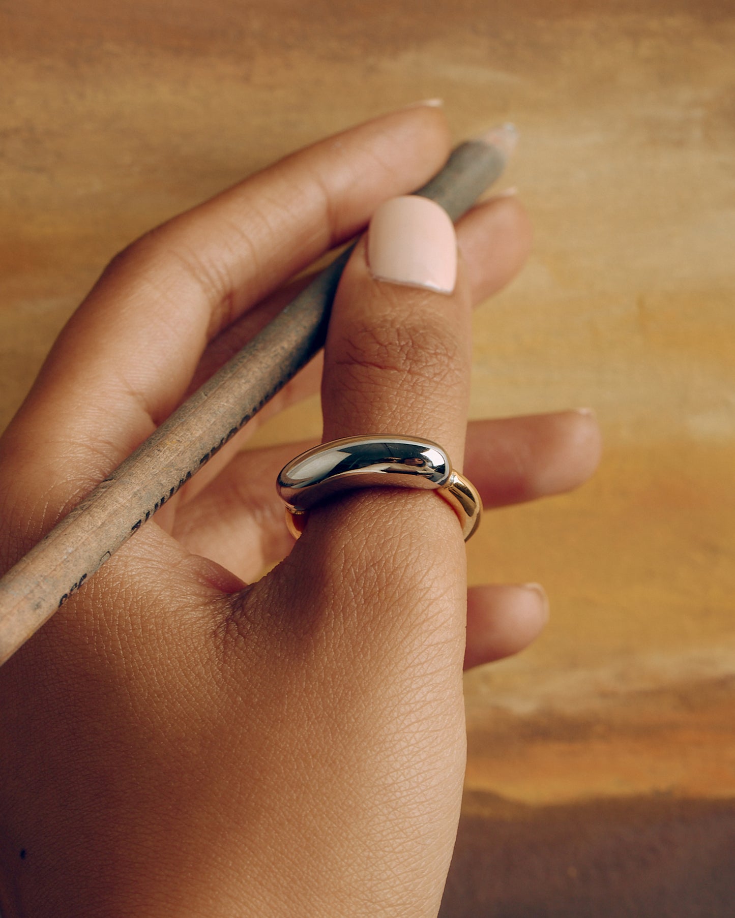 Chunky tubular ring in gold and silver tones – bold two-tone statement piece.