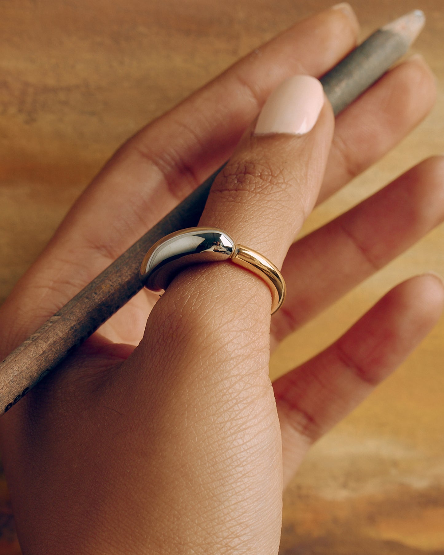 Chunky tubular ring in gold and silver tones – bold two-tone statement piece.