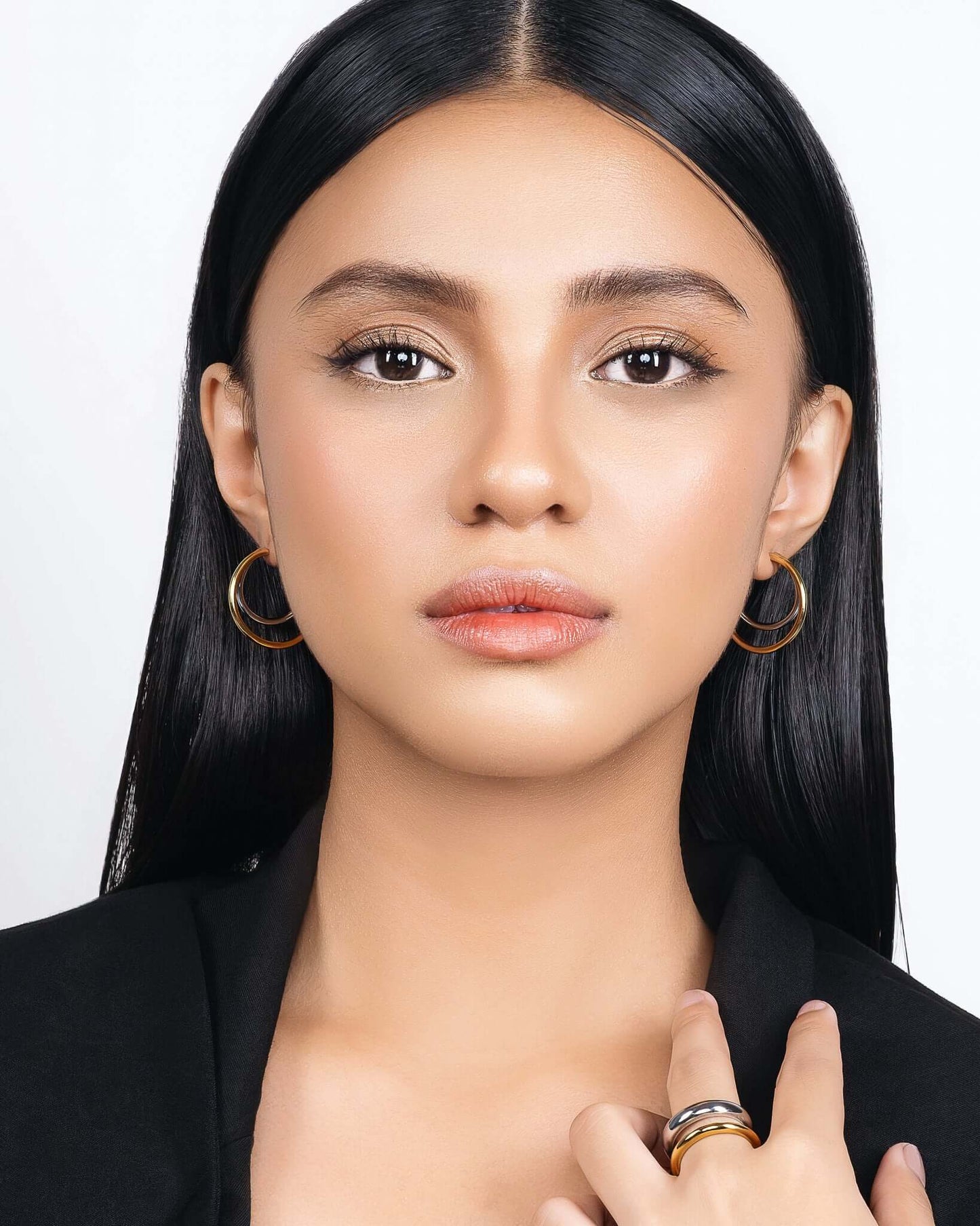 Modern two tone double hoop earrings featuring a polished gold outer hoop and silver inner hoop with secure tube lock closure, minimalist mixed metal statement earrings for everyday wear and modern jewelry styling.
