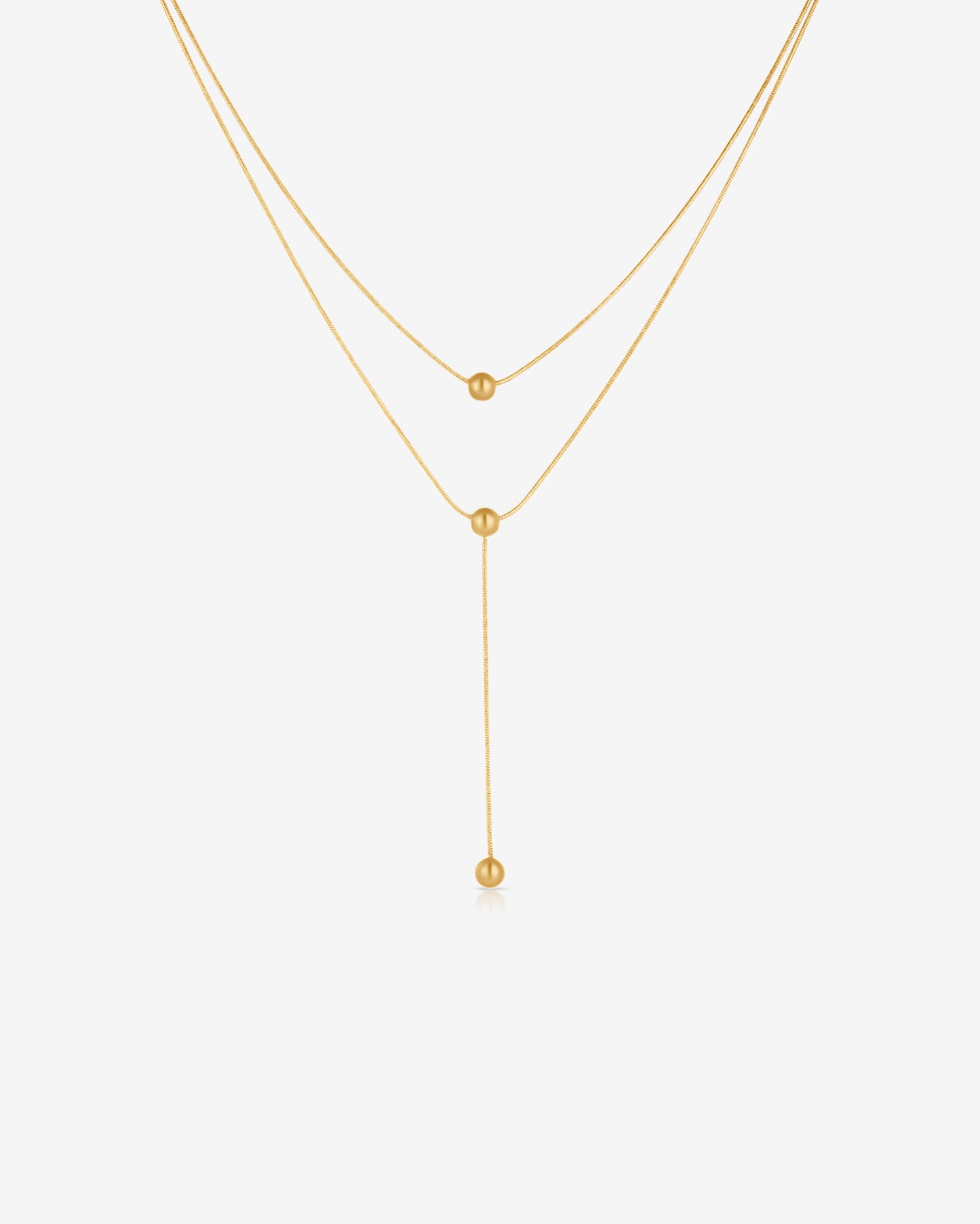 Double-strand 18K gold plated necklace with layered chains and polished ball pendants, delicate and modern for everyday or statement wear.