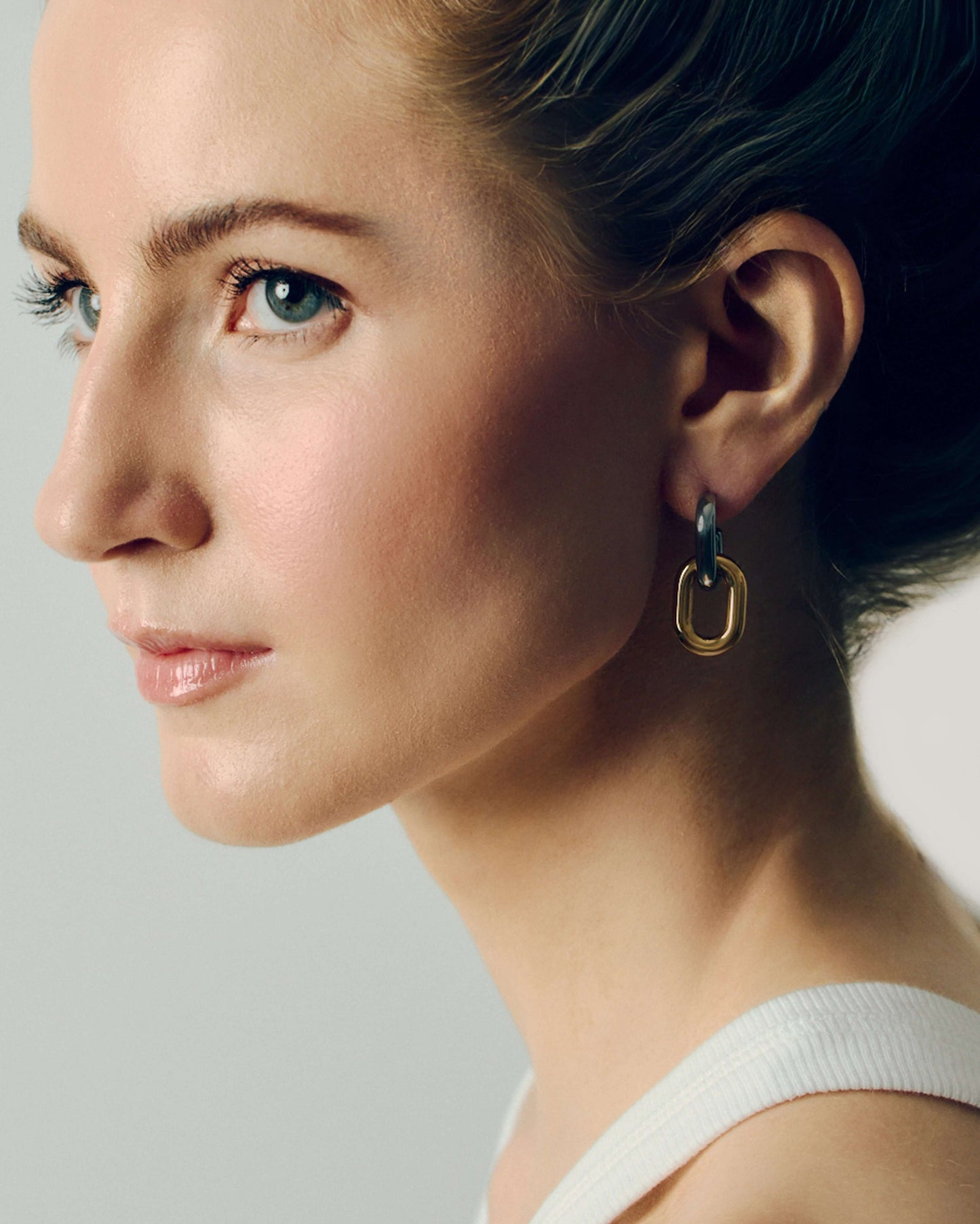Two-tone link drop earrings with chunky silver and gold oval links stacked together. Modern statement earrings with sleek polished finish, lightweight and easy to wear. Perfect for everyday outfits or adding a chic, bold touch to evening looks. Contemporary geometric design ideal for fashion-forward styling.