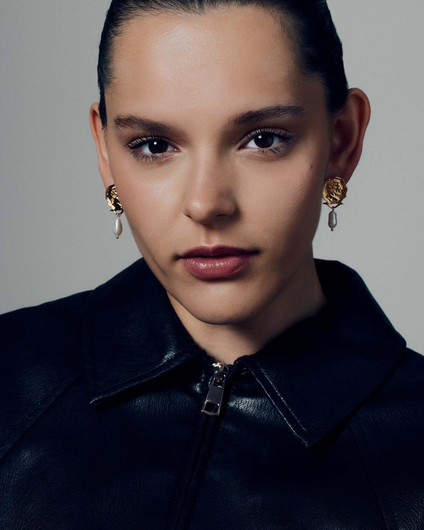 Gold coin pearl drop earrings featuring embossed medallion faces paired with natural baroque-style pearls. These sculptural statement earrings combine vintage inspiration with modern craftsmanship, offering a timeless yet bold look. Perfect for elevating everyday or occasion outfits with a touch of classic gold elegance.