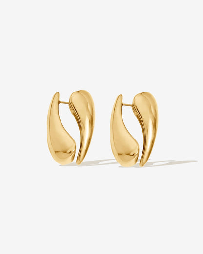 Gold hoop earrings with a modern sculptural shape. Made with two sides for a bold look, or wear as a single-side hoop for a simple style. High-shine finish, lightweight, and easy to wear day or night.