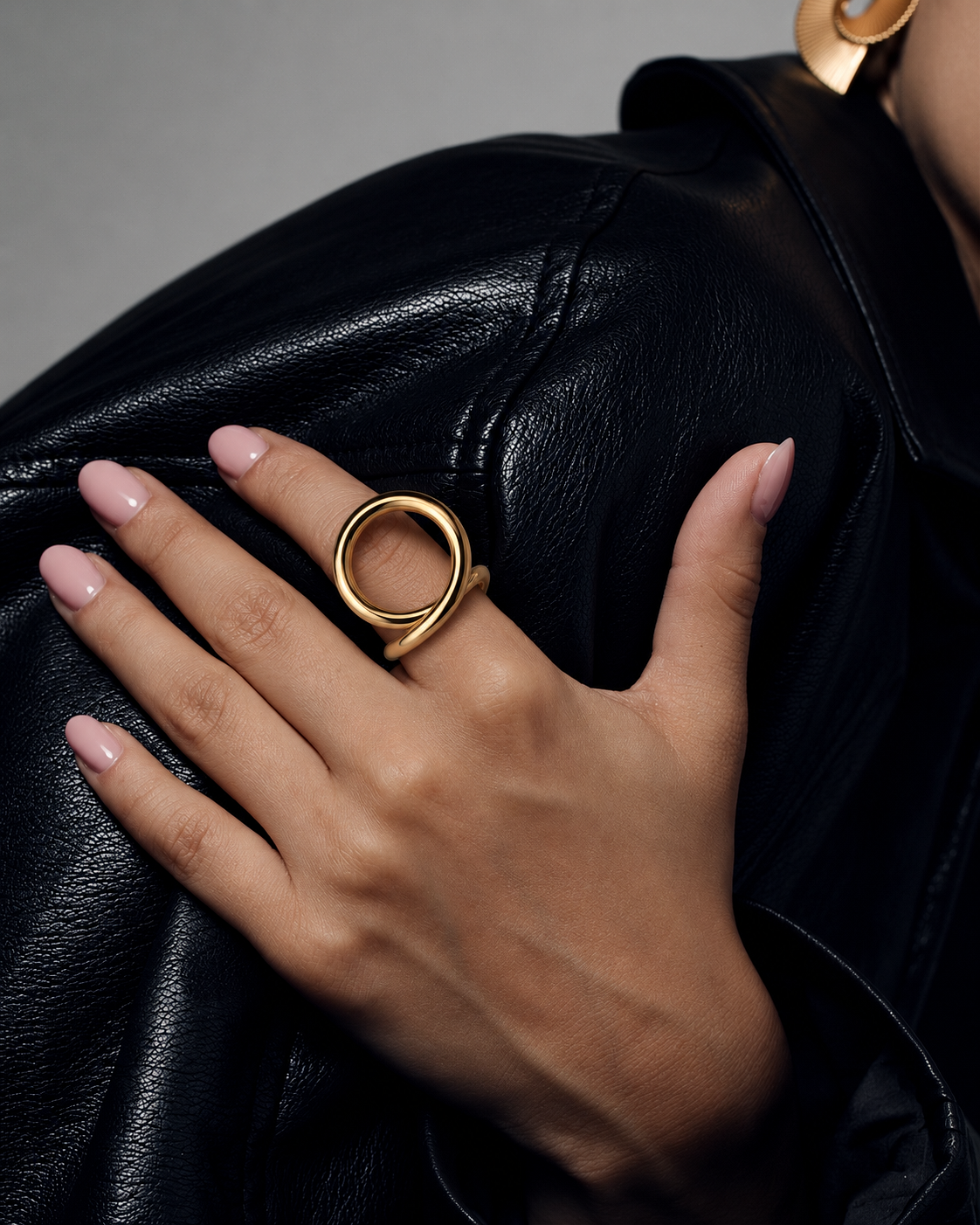 Sculptural loop ring in polished gold and silver with an oversized fluid open-loop silhouette and modern statement design by RRule