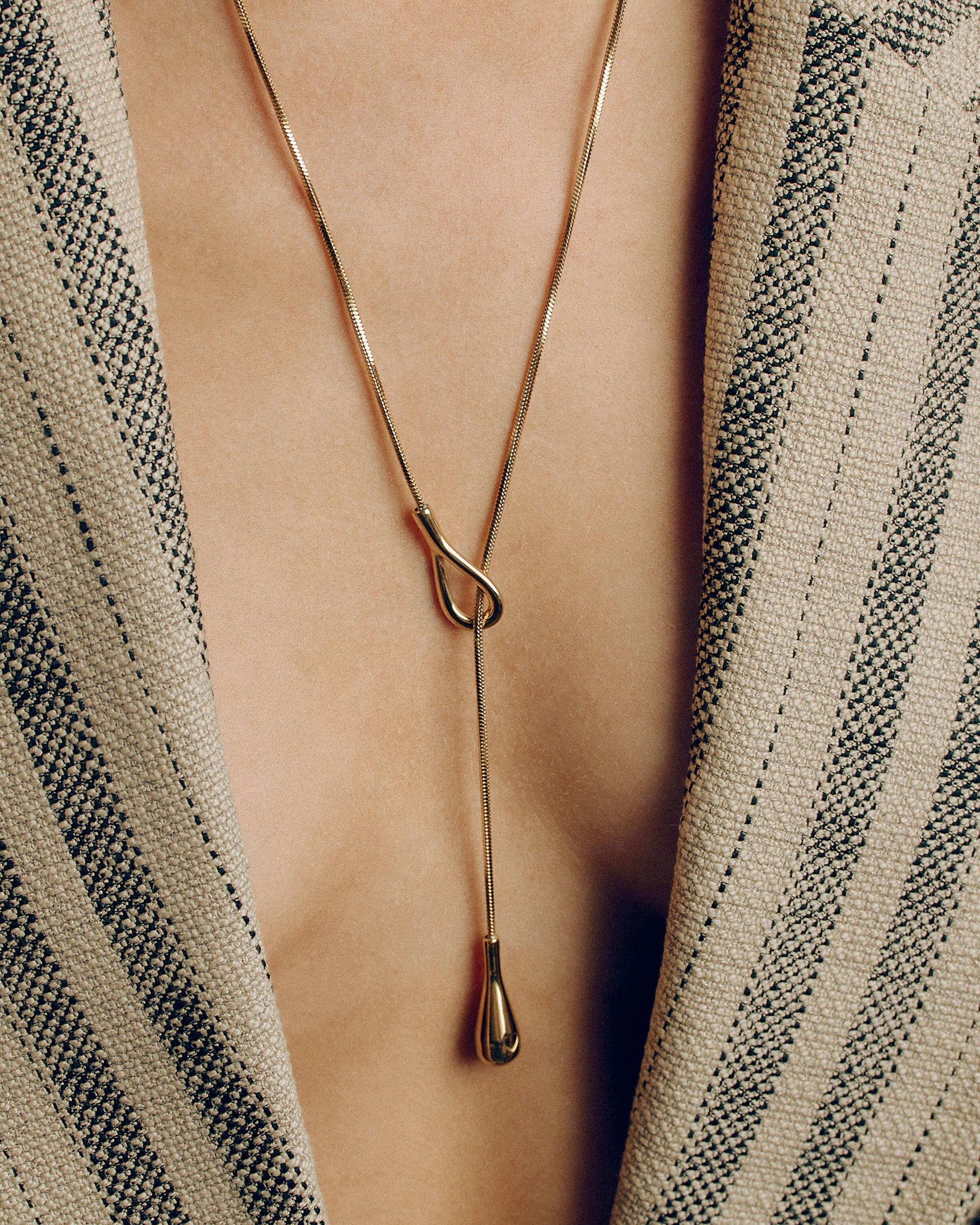 Adjustable gold or silver necklace worn long or as a choker, non-tarnish finish, versatile for layering or statement looks.