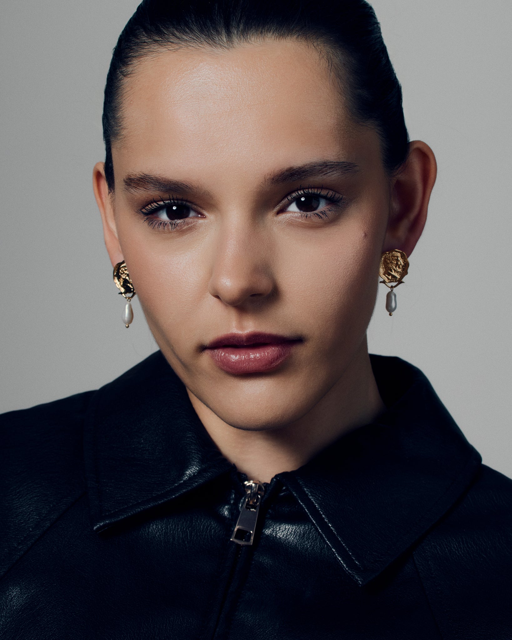 Gold coin pearl drop earrings featuring embossed medallion faces paired with natural baroque-style pearls. These sculptural statement earrings combine vintage inspiration with modern craftsmanship, offering a timeless yet bold look. Perfect for elevating everyday or occasion outfits with a touch of classic gold elegance.