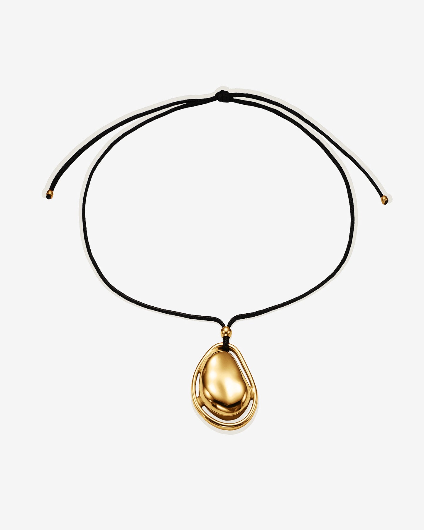 Gold necklace with a teardrop-shaped pendant on a black cord tie