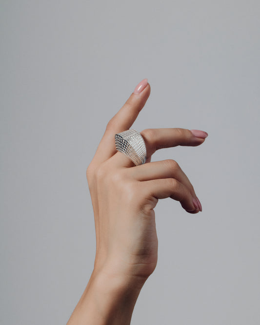 Gold open-work grid ring with a sculptural geometric pattern and bold rounded band. This chunky gold statement ring features a modern lattice texture that gives it depth and dimension while remaining lightweight and comfortable. Crafted in polished gold-tone metal, it adds a refined, architectural edge to everyday or occasion wear.
