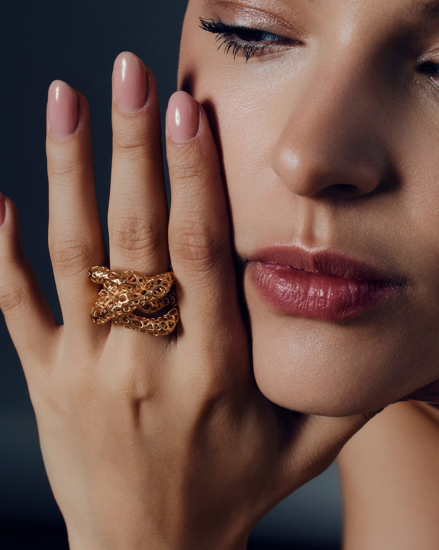 Gold open-work knot ring with a sculptural, intertwined design and wide textured band. This chunky statement ring features organic cutout details that create a bold yet airy look. Crafted in polished gold-tone metal, it blends modern artistry with everyday wearability — ideal as a solo statement piece or stacked with minimalist bands.