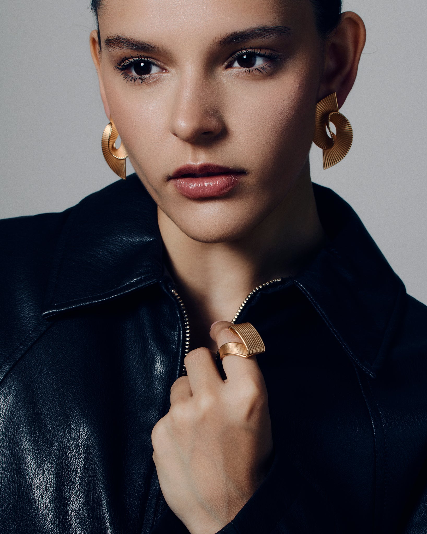 Pleated square gold ring featuring fine ridged detailing that flows seamlessly across the face and band. This sculptural textured ring combines a bold square shape with a soft pleated design, balancing modern geometry and fluid form. Crafted in polished gold-tone metal, it’s a statement piece for everyday or occasion wear.