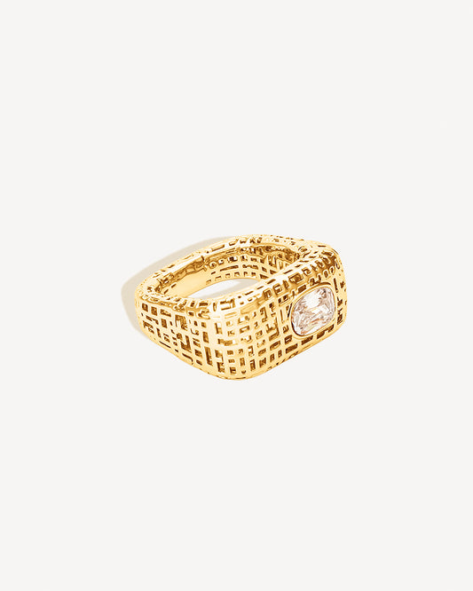 Open work square gold statement ring with clear stone centerpiece, featuring a sculptural grid-textured design and polished finish. This chunky modern ring adds bold structure and elegance to any look, crafted in durable non-tarnish metal with a distinctive geometric open pattern that reflects light beautifully.