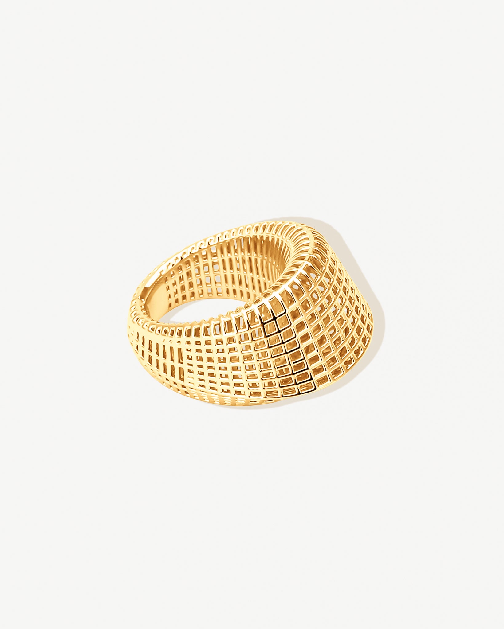 Close-up of a gold open-work grid ring featuring a wide band with geometric cutout design. The chunky 18k gold-plated stainless steel ring is non-tarnish, water-resistant, and hypoallergenic. Its sculptural, architectural-inspired open-work detailing creates a bold yet airy statement piece, ideal as a cocktail ring, stacking ring, or everyday fashion accessory.