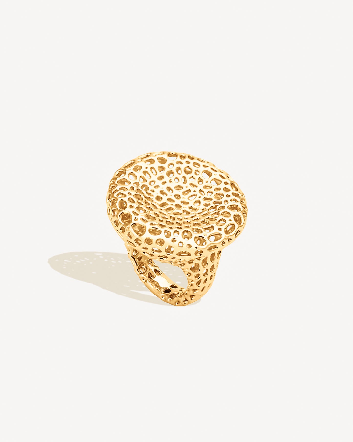 Close-up of a gold open-work dome ring with a bold bubble texture and sculptural cutout design. Crafted in 18k gold-plated stainless steel, this chunky statement ring features a wide dome silhouette with airy open-work detailing. Non-tarnish, hypoallergenic, and water-resistant, it’s perfect as a cocktail ring, bold everyday accessory, or sculptural jewelry piece.