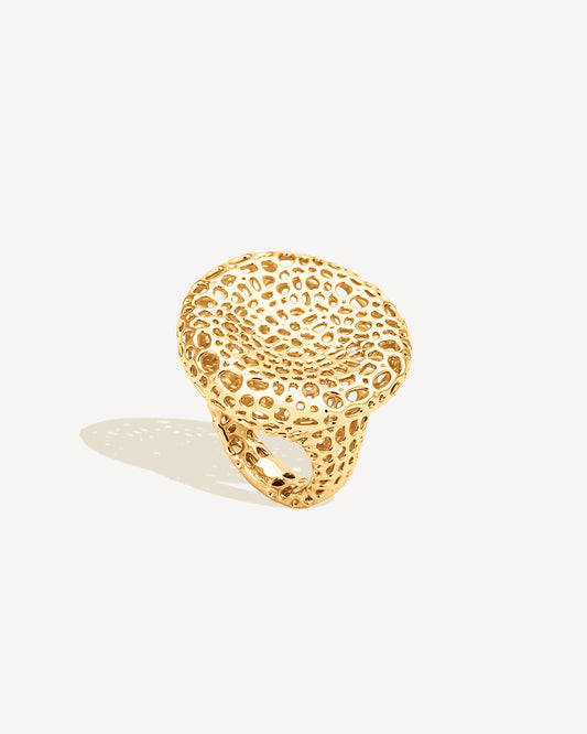 Close-up of a gold open-work dome ring with a bold bubble texture and sculptural cutout design. Crafted in 18k gold-plated stainless steel, this chunky statement ring features a wide dome silhouette with airy open-work detailing. Non-tarnish, hypoallergenic, and water-resistant, it’s perfect as a cocktail ring, bold everyday accessory, or sculptural jewelry piece.