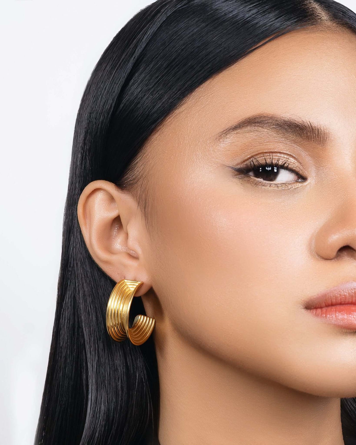 Chunky ribbed hoop earrings in gold finish, bold textured hoop earrings for women, modern statement hoops, layered ribbed design jewelry, trendy chunky gold earrings for everyday wear or elevated styling