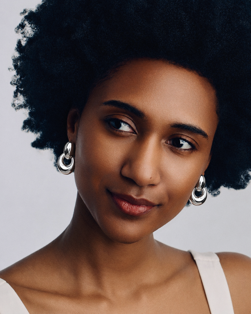 Chunky oval drop earrings in gold and silver, polished statement earrings with a sculptural open hoop design, modern bold jewelry by RRule