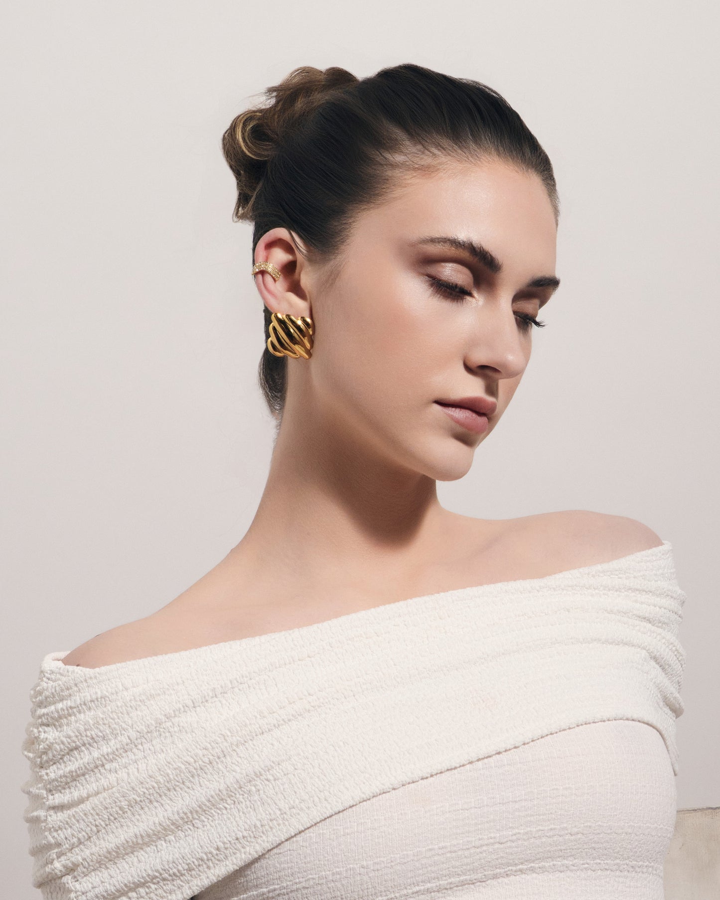 Chunky ribbed gold square stud earrings with sculptural dome design for modern everyday wear.