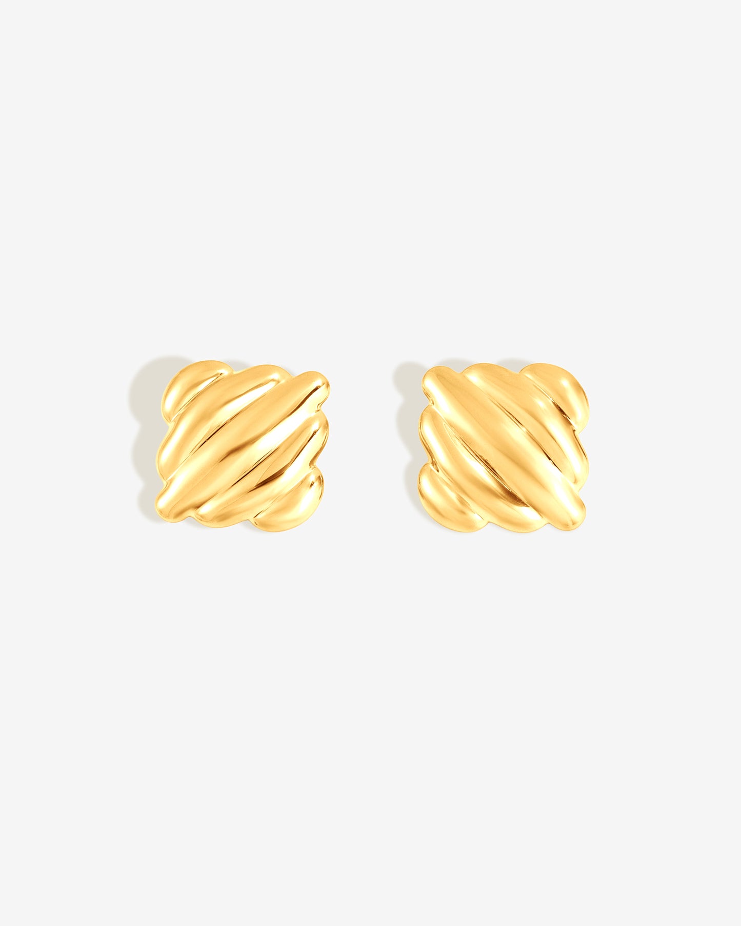 Chunky ribbed gold square stud earrings with sculptural dome design for modern everyday wear.