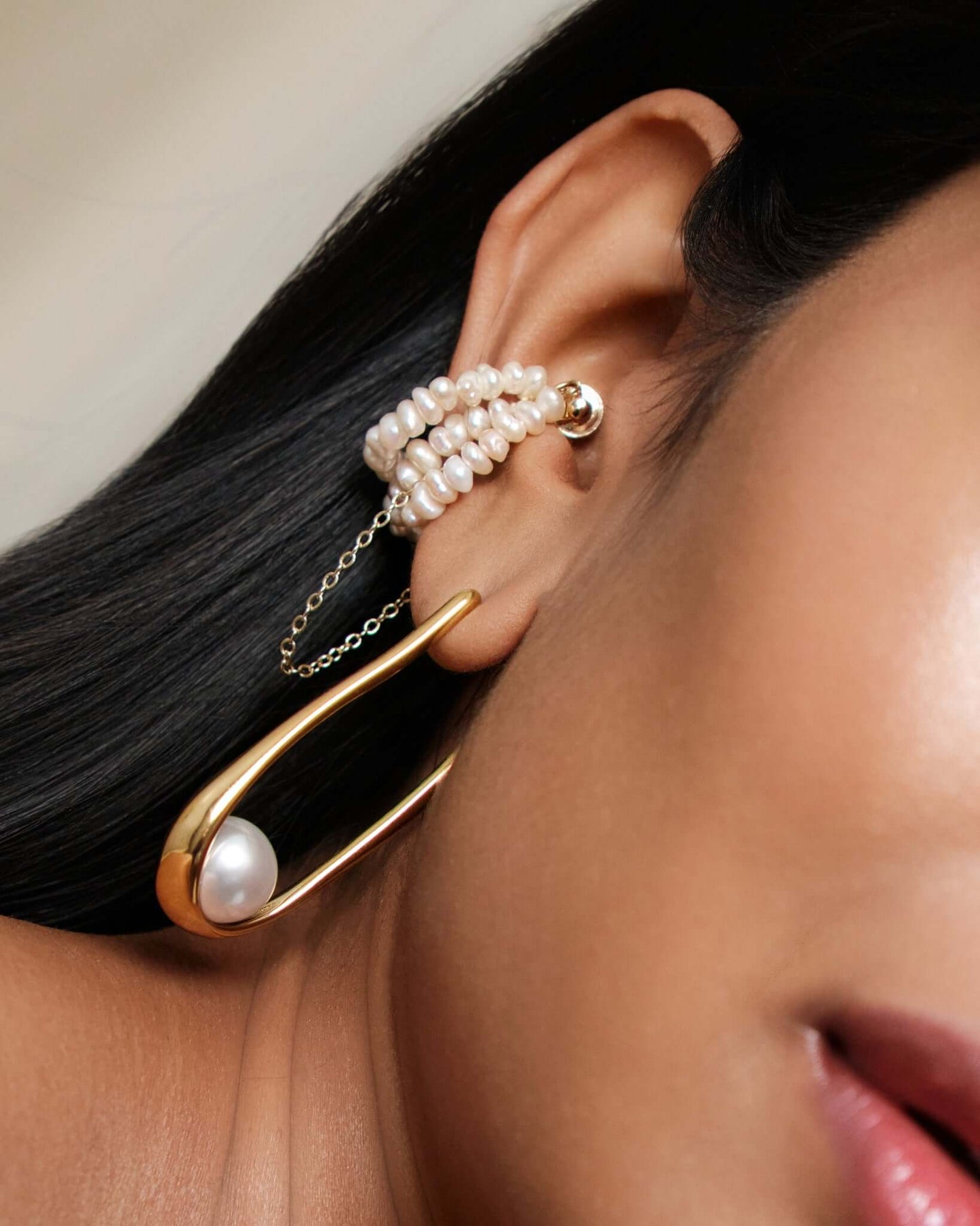 Freshwater pearl ear cuff with gold chain detail, no piercing cartilage cuff worn on ear