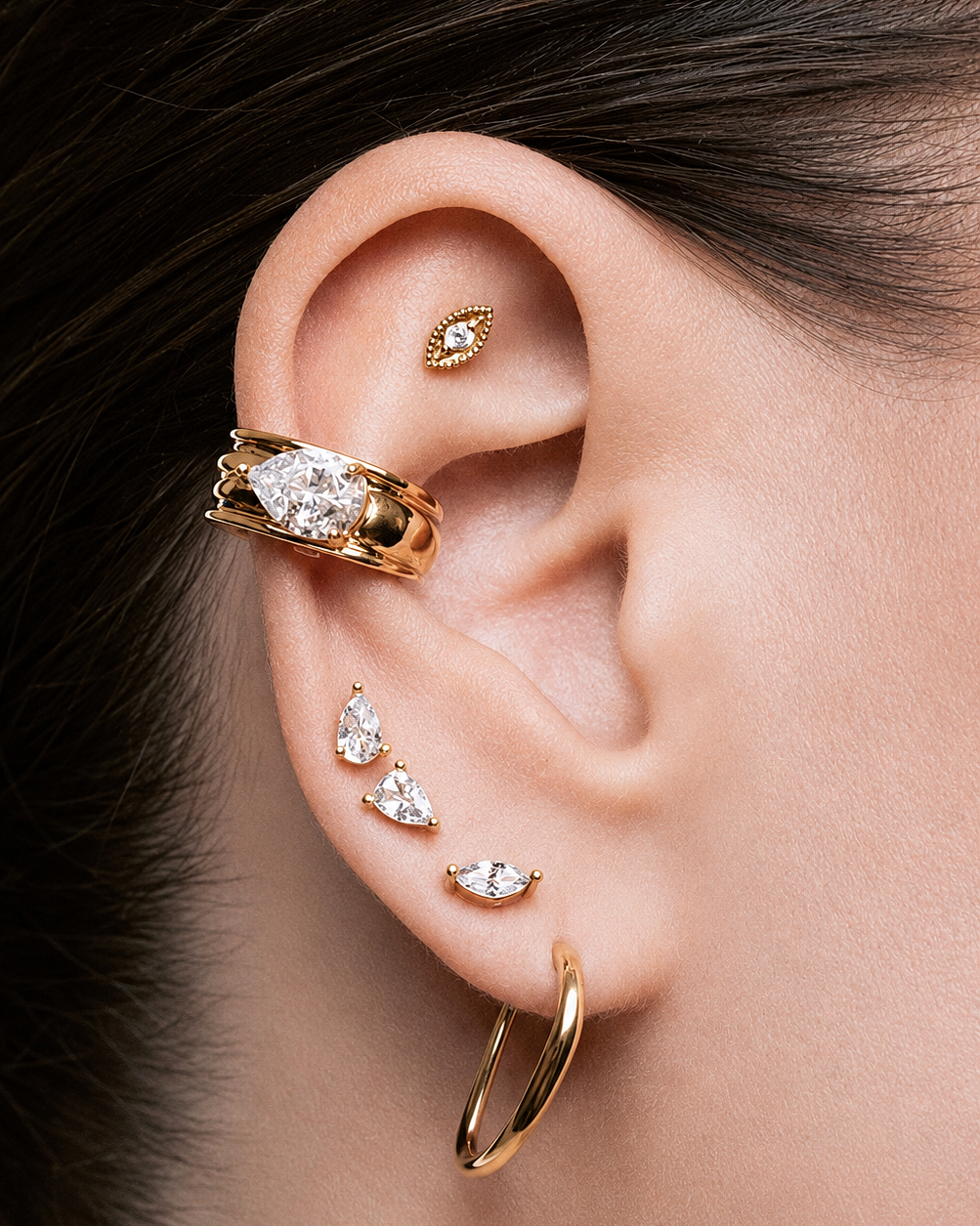 Gold Marquise Ear Cuff Set featuring a sparkling marquise crystal cuff and a matching plain cuff. Non-pierced statement ear cuffs designed for asymmetrical ear stacks, modern styling, and everyday wear.
