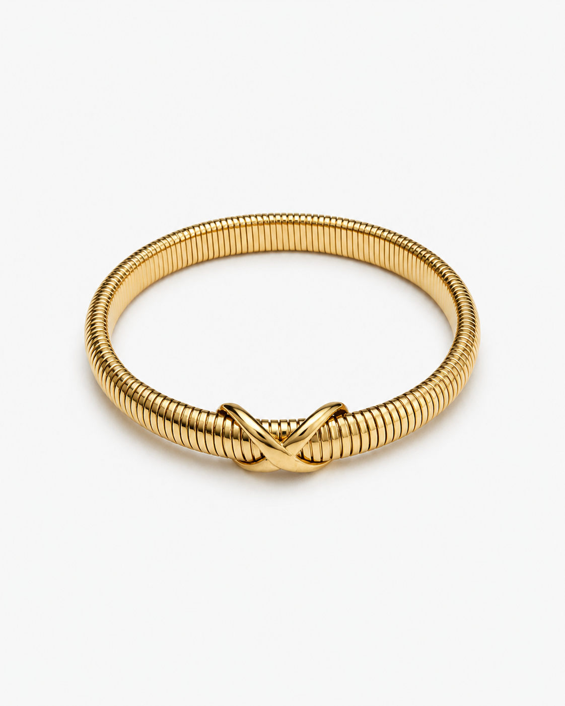 Knot bangle bracelet in gold and silver with flexible ribbed coil design and sculptural knot detail