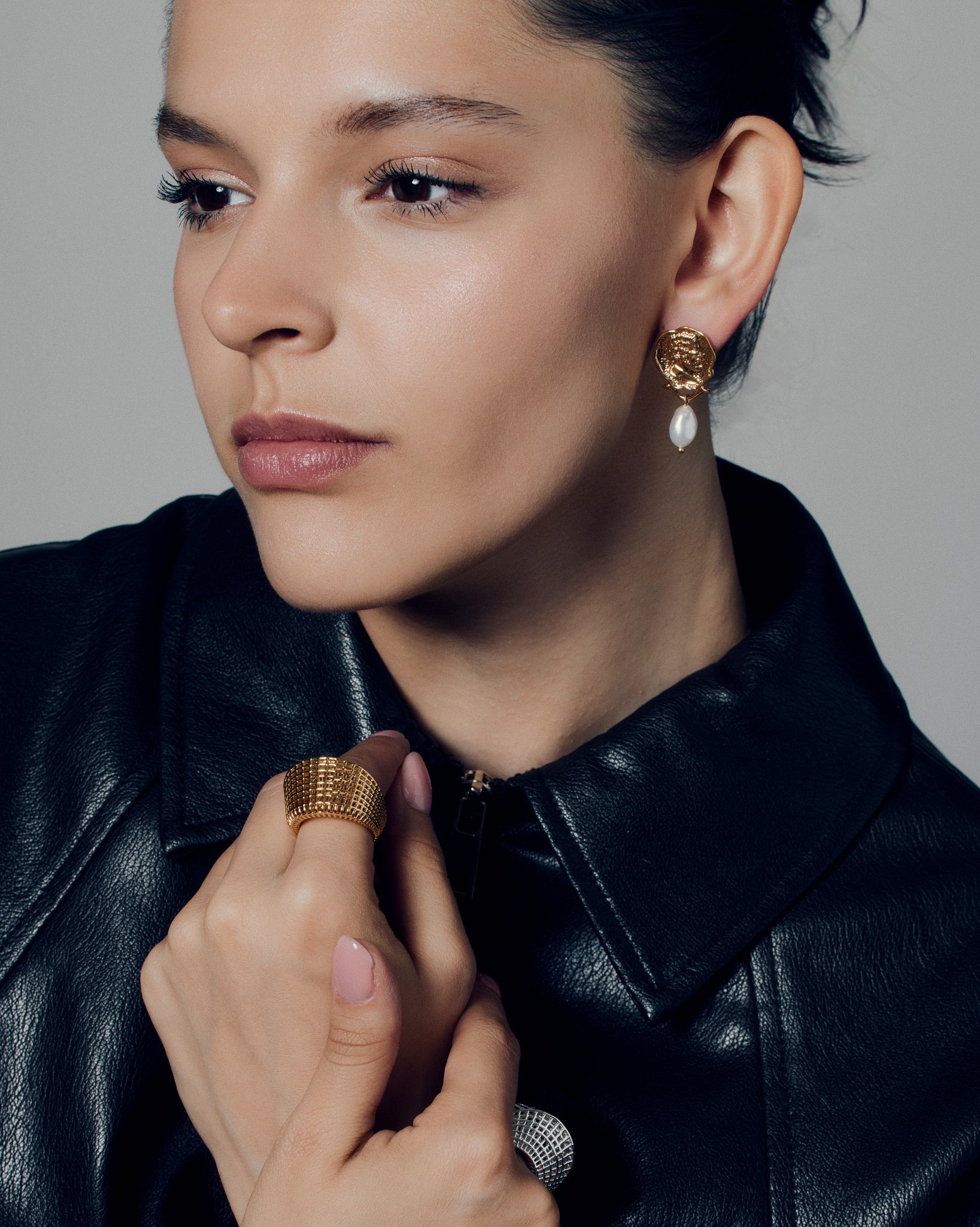 Gold coin pearl drop earrings featuring embossed medallion faces paired with natural baroque-style pearls. These sculptural statement earrings combine vintage inspiration with modern craftsmanship, offering a timeless yet bold look. Perfect for elevating everyday or occasion outfits with a touch of classic gold elegance.