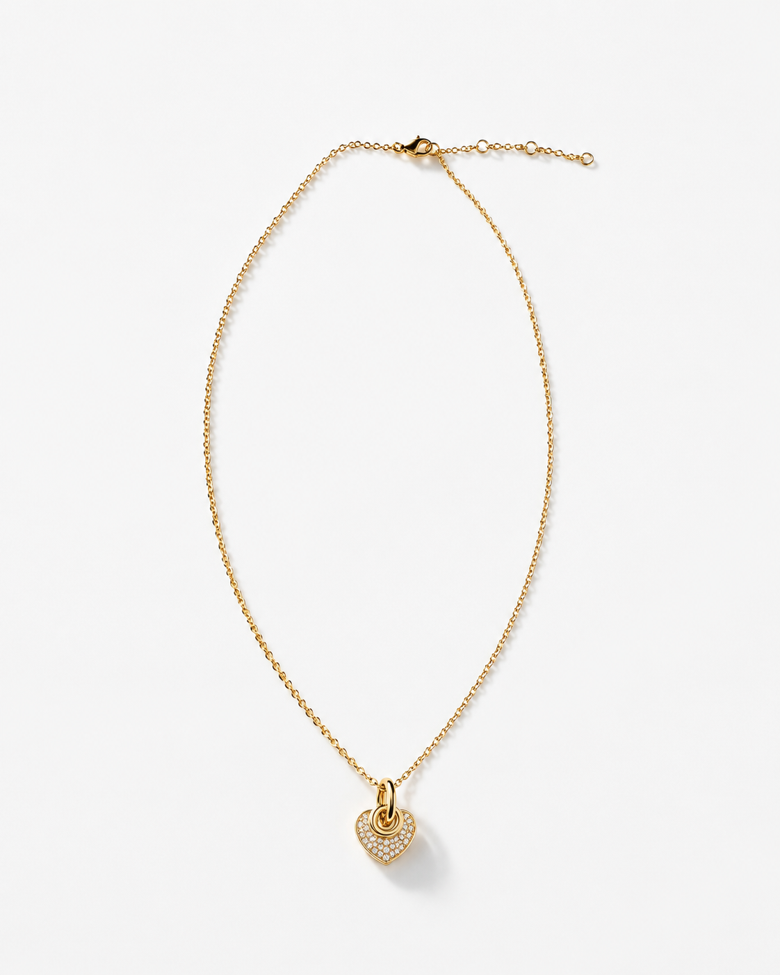 A delicate gold chain necklace with a small heart-shaped pendant adorned with tiny clear stones, displayed on a clean white background.