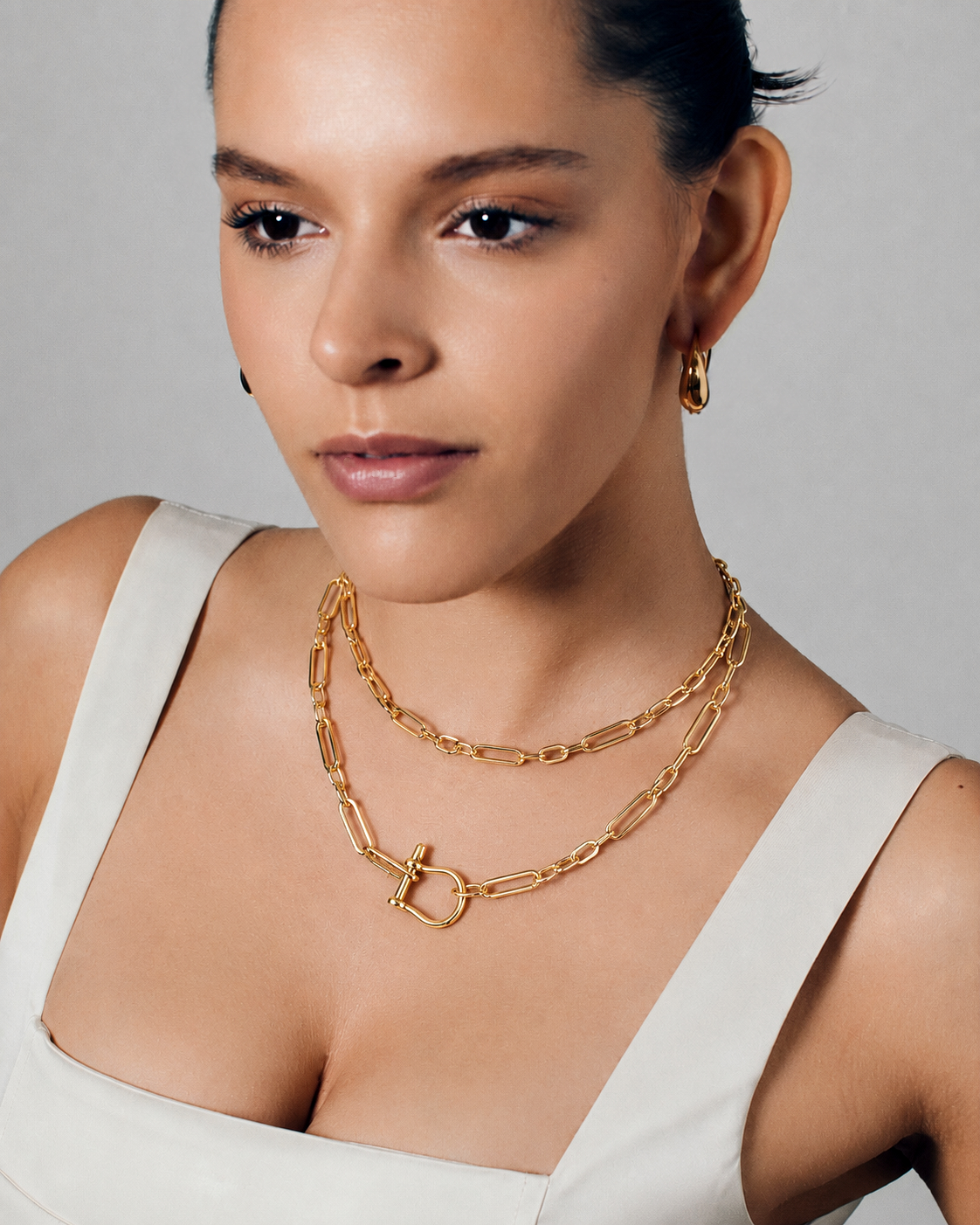 Long link chain toggle necklace in polished gold featuring elongated open links, sculptural horseshoe toggle clasp and versatile long or doubled styling by RRule