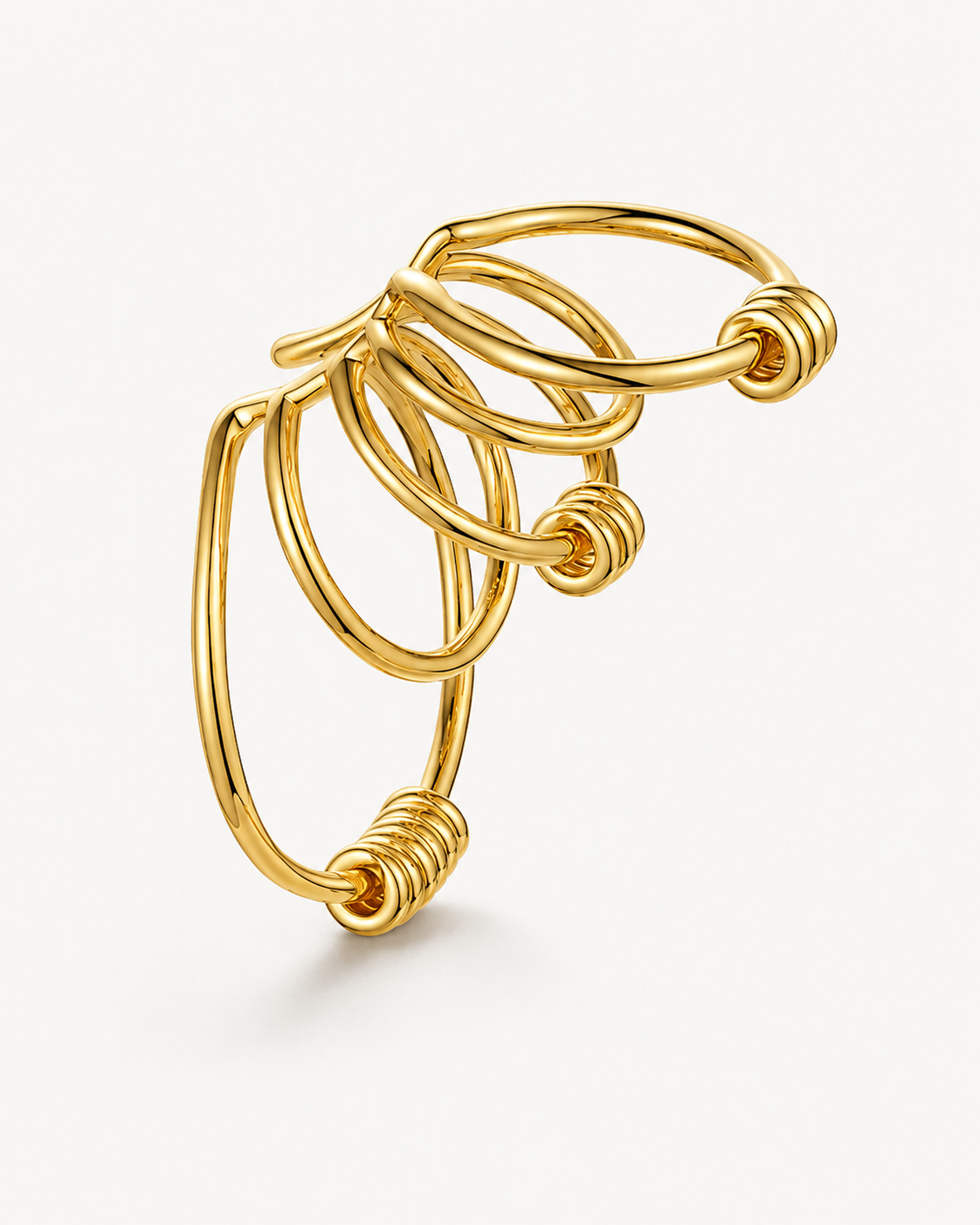 Statement ear cuff in gold featuring a sculptural multi loop design