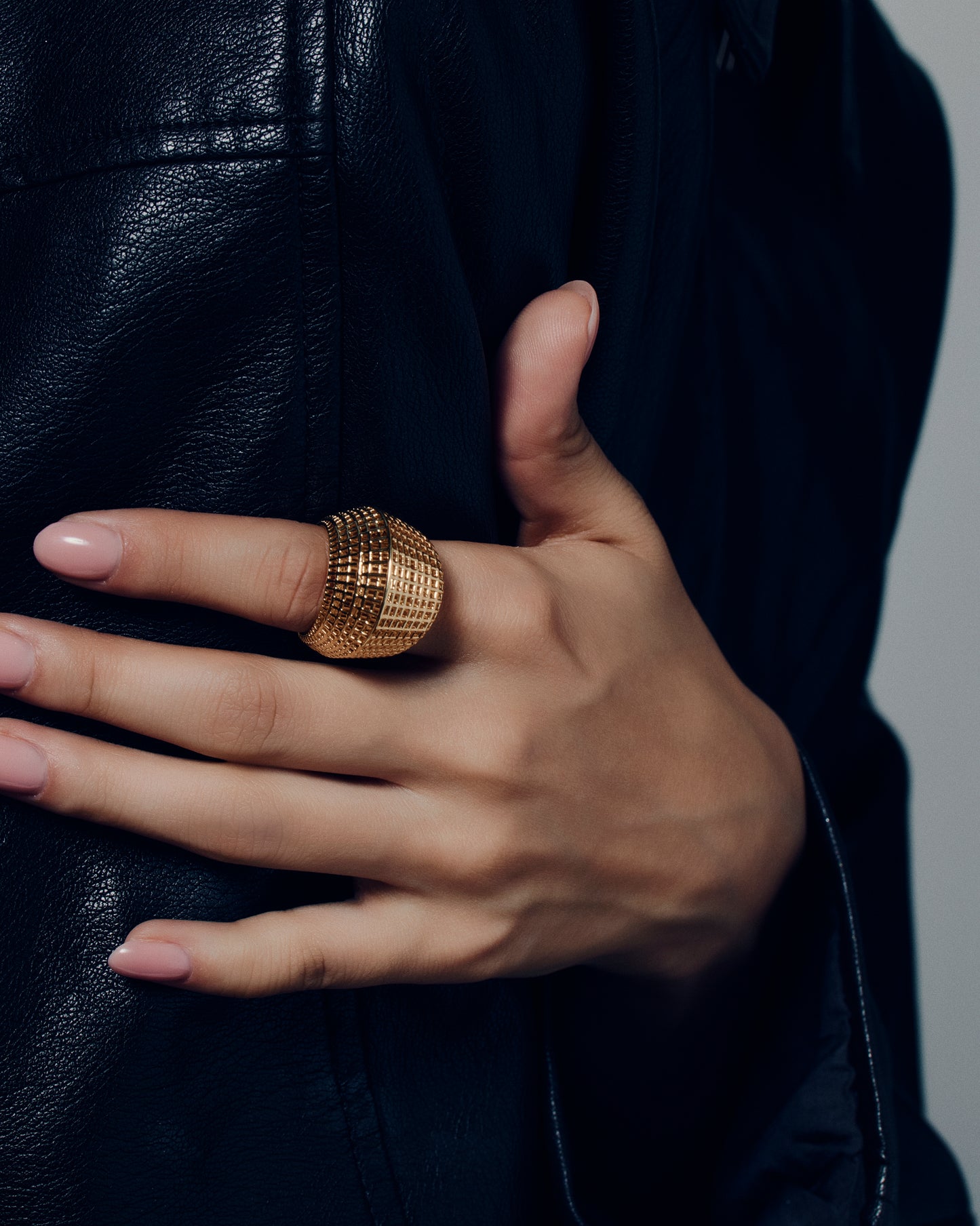 Gold open-work grid ring with a sculptural geometric pattern and bold rounded band. This chunky gold statement ring features a modern lattice texture that gives it depth and dimension while remaining lightweight and comfortable. Crafted in polished gold-tone metal, it adds a refined, architectural edge to everyday or occasion wear.