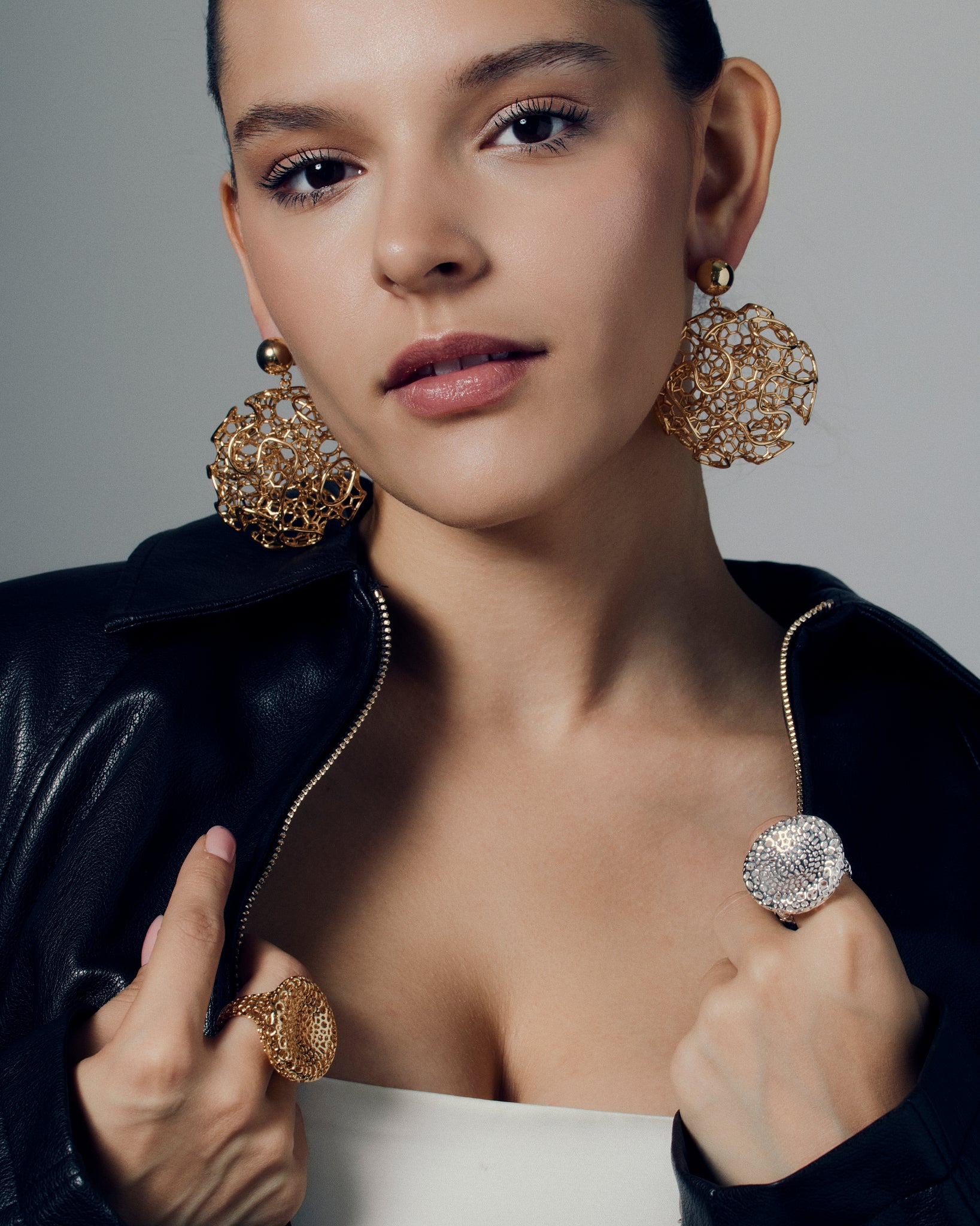 Gold filigree statement earrings featuring a sculptural open-work orb design with intricate detailing and polished gold finish. These large hollow drop earrings blend traditional filigree artistry with a modern, sculptural form, creating a bold yet refined statement. Perfect for those who love elegant, lightweight, and wearable art jewelry.