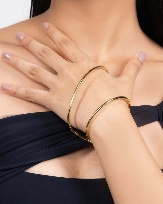Sculptural palm bracelet in gold tone, modern statement hand bracelet with open cuff design, minimalist arm jewelry for women, bold contemporary gold bracelet, elegant fashion accessory for special occasions or everyday styling