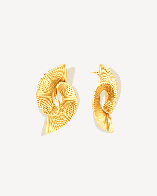 Pleated sculptural gold earrings featuring a twisted, folded design with fine ridged texture. These bold statement earrings have an open curved form that adds dimension and movement. Crafted in polished gold-tone metal, they bring a modern, architectural edge to any outfit — lightweight yet striking for everyday or occasion wear.