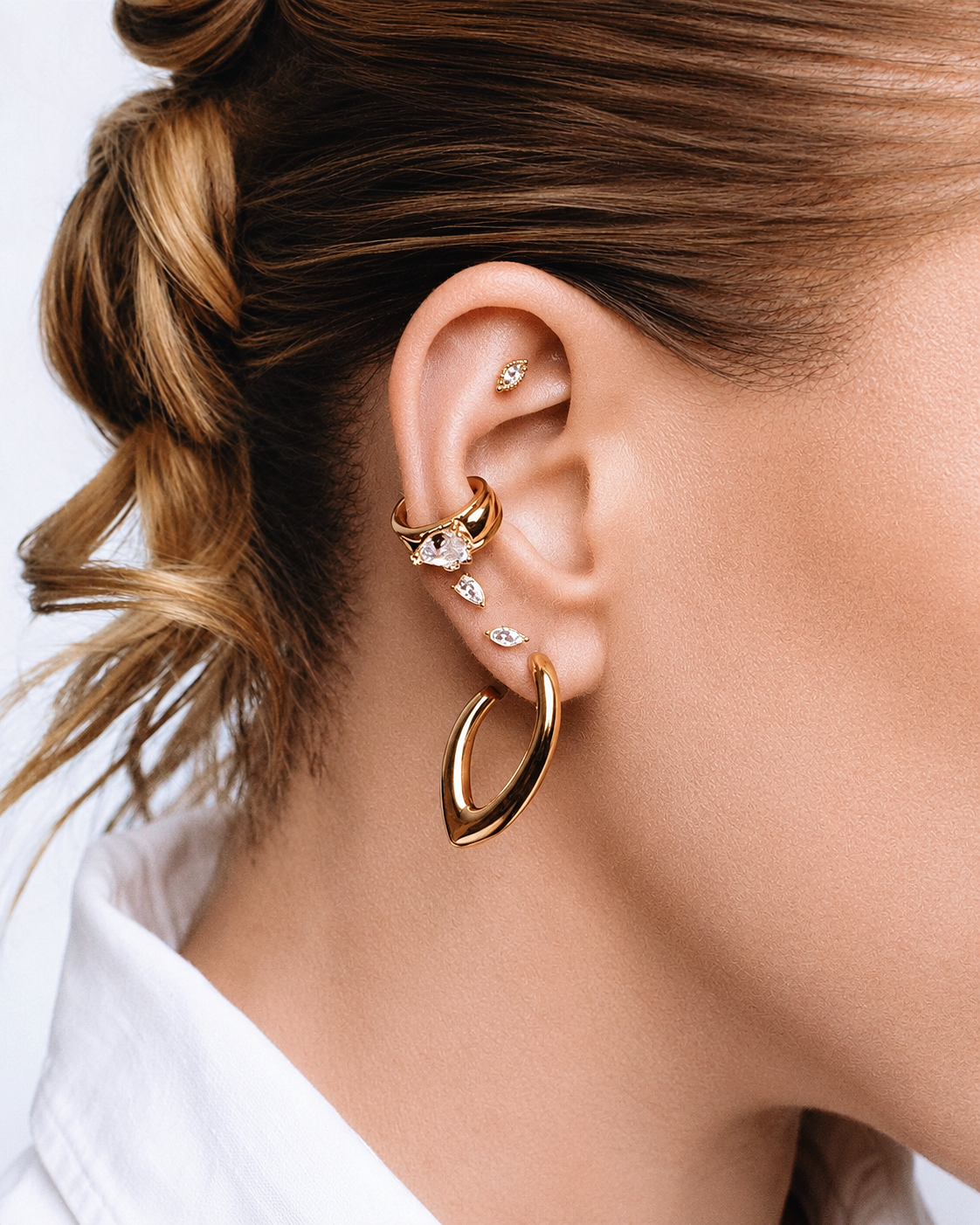 Gold Marquise Ear Cuff Set featuring a sparkling marquise crystal cuff and a matching plain cuff. Non-pierced statement ear cuffs designed for asymmetrical ear stacks, modern styling, and everyday wear.