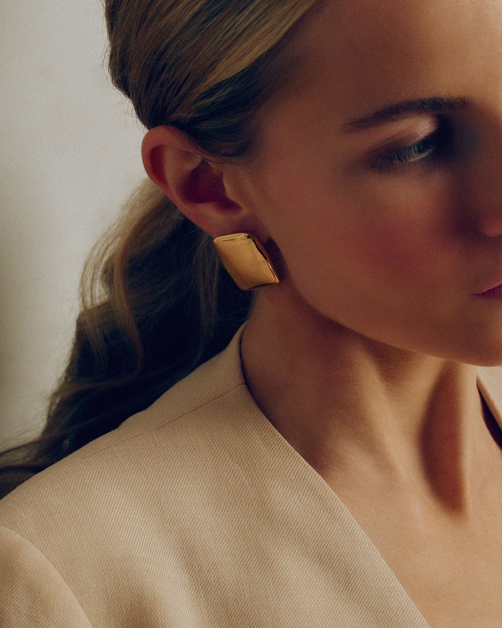 Bold gold rectangle stud earrings with a chunky, sculptural design and high-shine finish. Modern geometric statement studs perfect for everyday or occasion wear.
